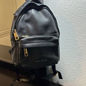 Marc Jacobs Black Pebbled Leather Backpack with Gold Hardware.